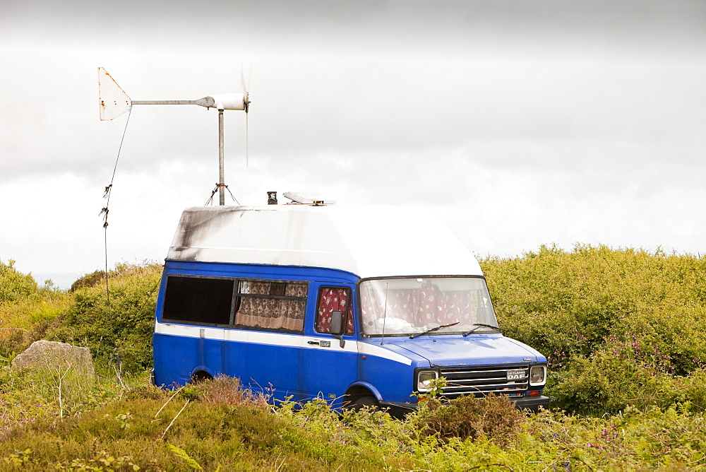 A traveller's camper van with a wind turbine used to power a computer and other electrical equipment near Zennor, Cornwall, England, United Kingdom, Europe