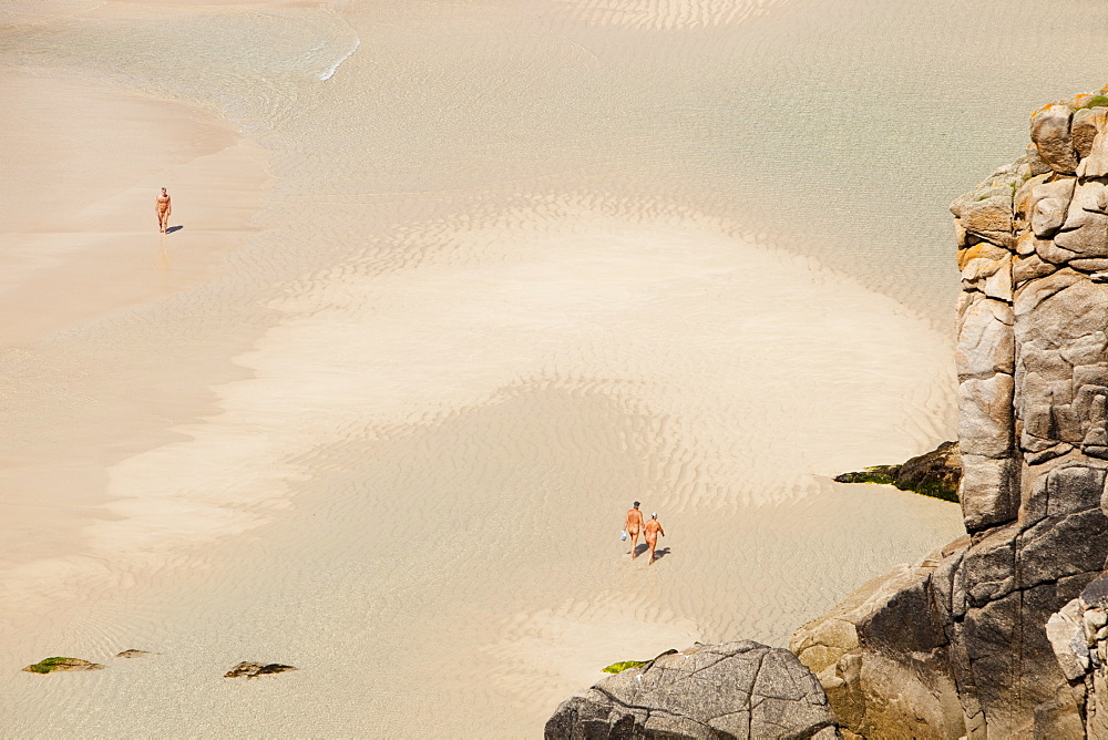 Nude bathers on a nudism beach at Porthcurno, Cornwall England, United Kingdom, Europe