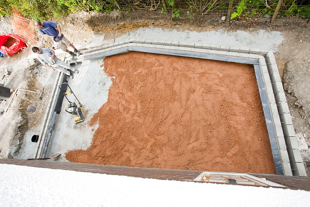 Builders prepare the floor of a house extension ready for the concrete floor to be poured, United Kingdom, Europe