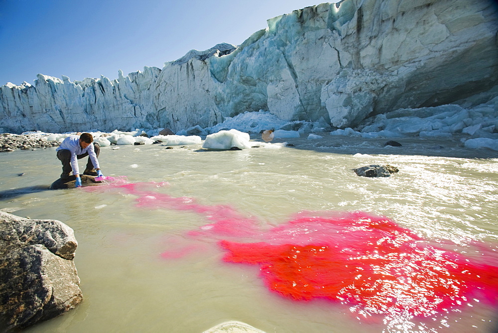 PHD scientist Ian Bartholomew using dye tracing techniques as part of a study to measure the speed of the Russell Glacier near Kangerlussuaq, Greenland, Polar Regions