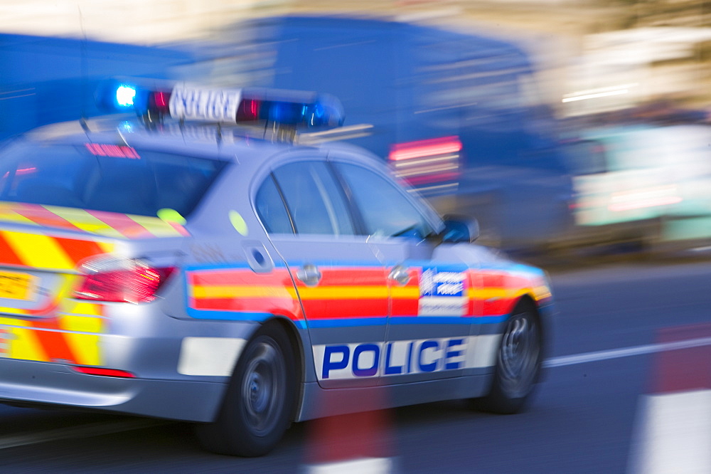 A police car speeding through the streets of London, England, United Kingdom, Europe