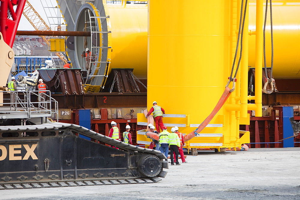 The yellow transition pieces that will hold the tower and turbine, that fit onto the monopile to hold the structure to the sea bed, Walney Offshore Wind Farm, Barrow in Furness, Cumbria, England, United Kingdom, Europe