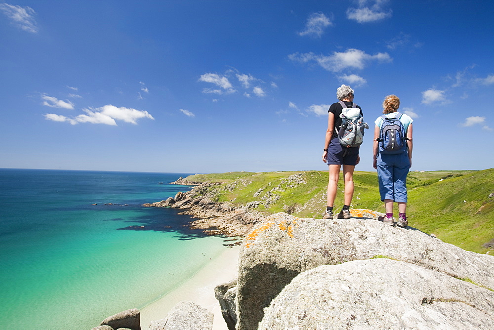 Walkers overlooking Porthcurno beach, Cornwall, England, United Kingdom, Europe