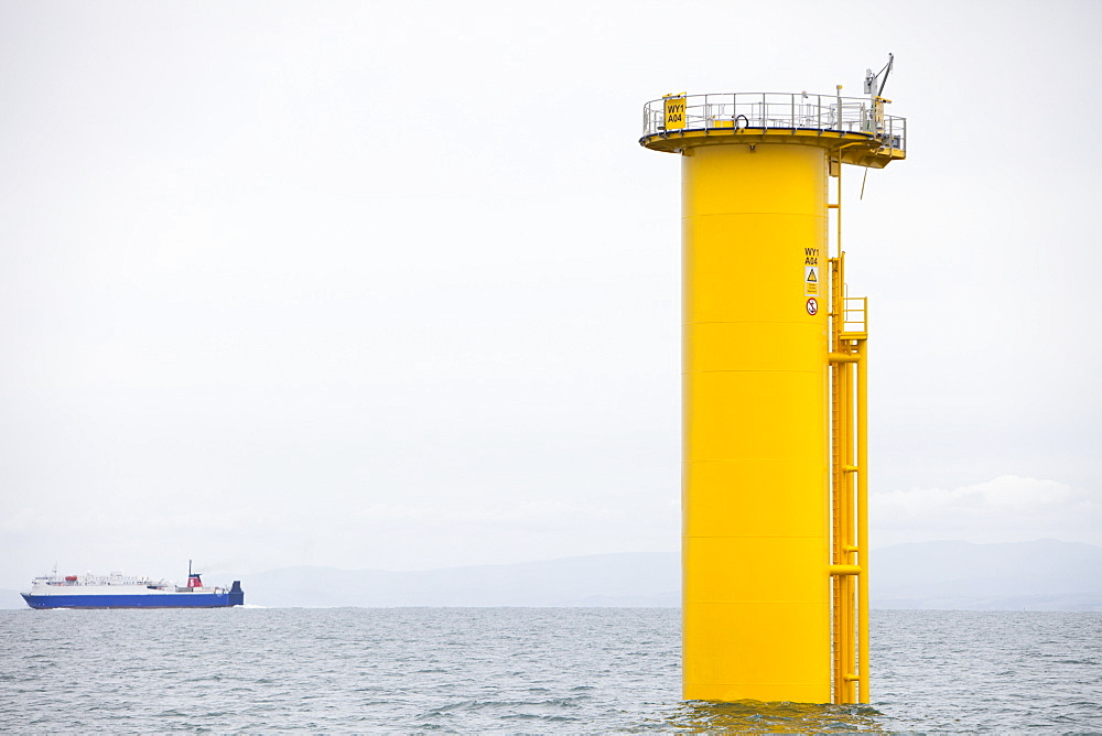 The yellow transition pieces that will hold the tower and turbine, that fit onto the monopile to hold the structure to the sea bed, Walney Offshore Wind Farm, Barrow in Furness, Cumbria, England, United Kingdom, Europe