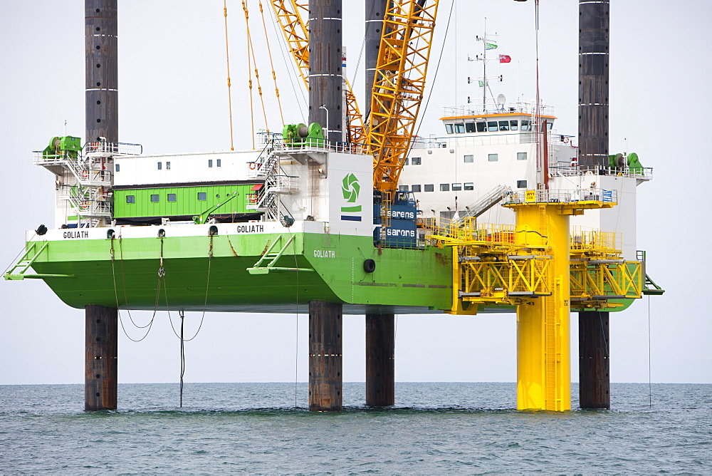 The jack up barge that hammers the monopiles into the sea bed fits a transition piece onto the top of the monopile, Walney Offshore Wind Farm, Cumbria, England, United Kingdom, Europe