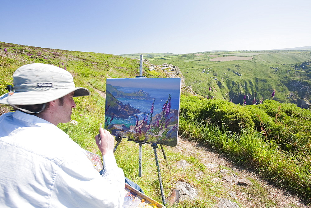 An artist painting outdoors on Zennor Head in Cornwall England, United Kingdom, Europe