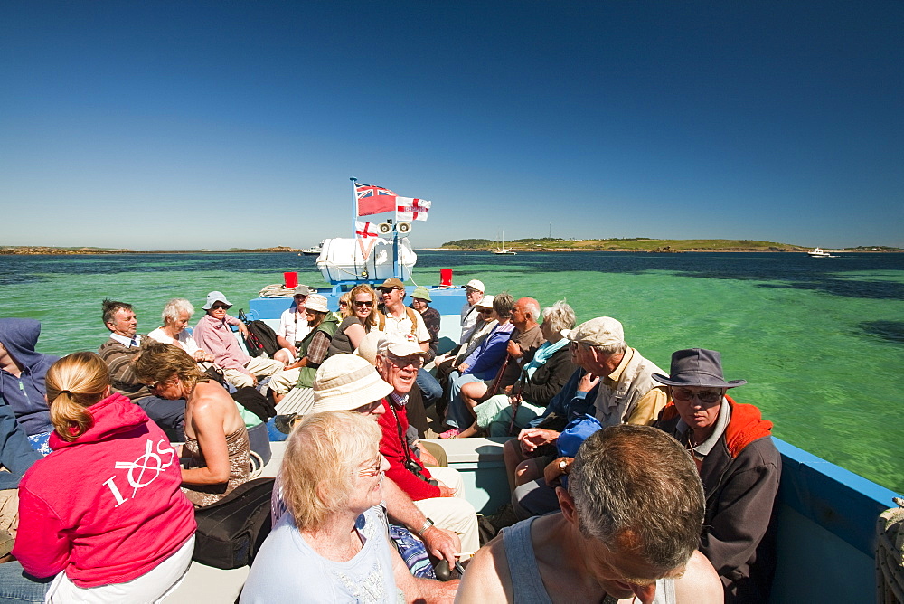 Tourists on a small passenger boat from Tresco to St. Mary's, Isles of Scilly, United Kingdom, Europe