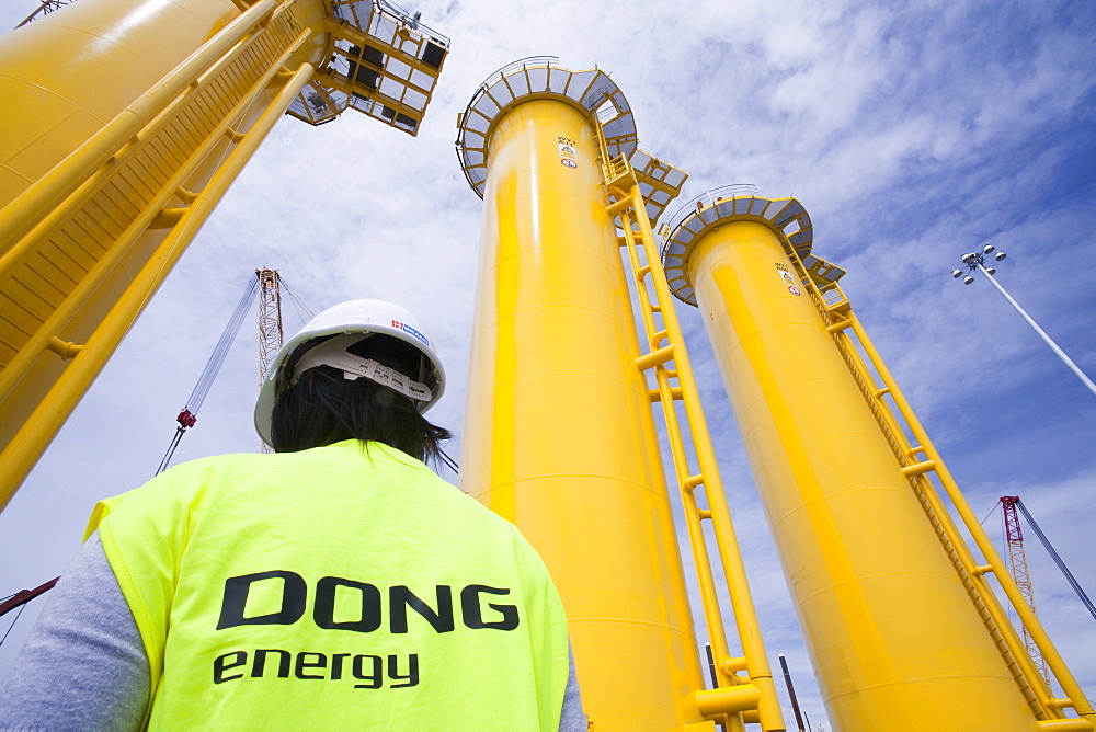 The yellow transition pieces that will hold the tower and turbine, that fit onto the monopile to hold the structure to the sea bed, Walney Offshore Wind Farm, Barrow in Furness, Cumbria, England, United Kingdom, Europe