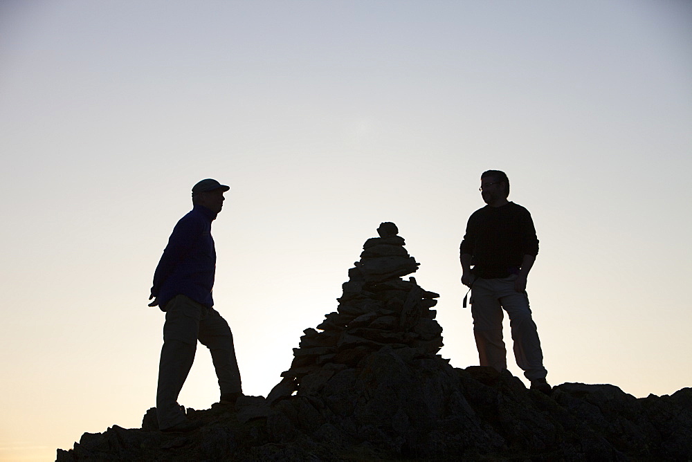 Hill walkers at dusk on Nab Scar in the Lake District, Cumbria, England, United Kingdom, Europe