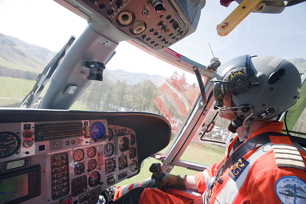 North West Air Ambulance pilot flies mountain rescue team members to a casualty site on the Langdale Pikes, Lake District, Cumbria, England, United Kingdom, Europe