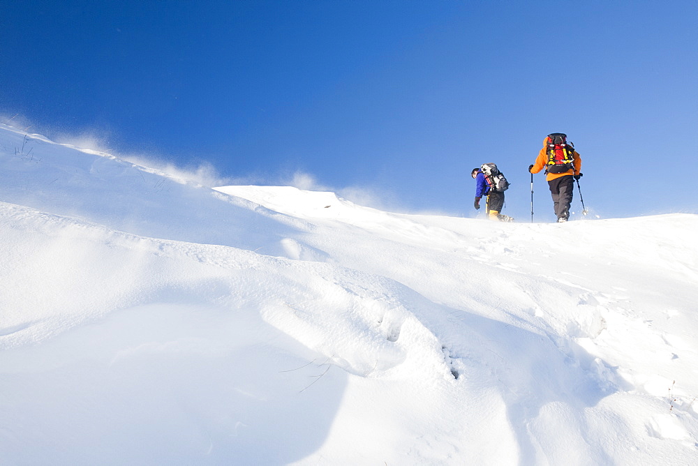 Climbers being blasted by spindrift during high winds moving snow above Grasmere in the Lake District, Cumbria, England, United Kingdom, Europe