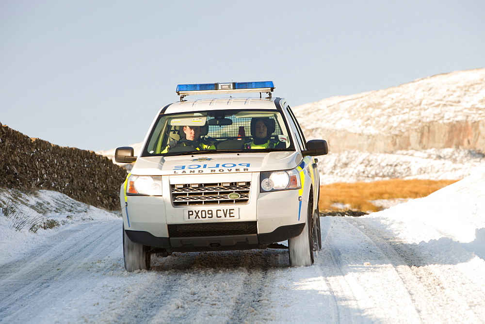 Police four wheel drive on Kirkstone Pass in snowy conditions, Lake District, Cumbria, England, United Kingdom, Europe