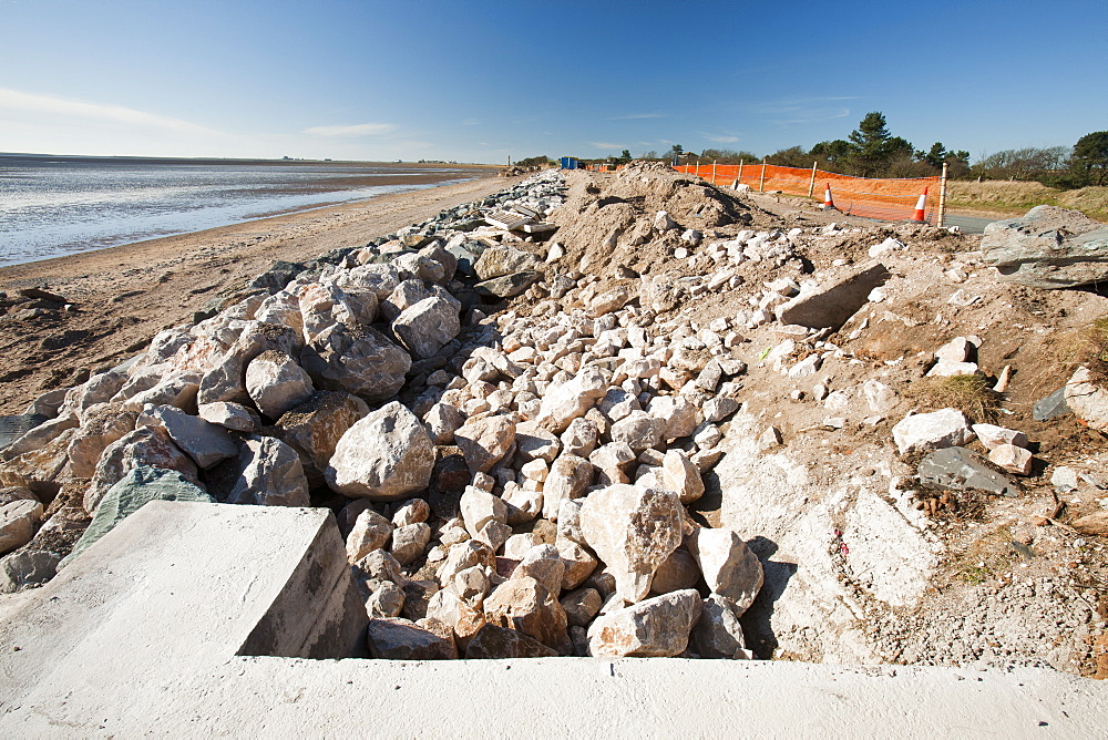 Repairing the sea wall damaged and breached by storms on the coast road near Barrow in Furness, between Rampside and Baycliff, Cumbria, England, United Kingdom, Europe