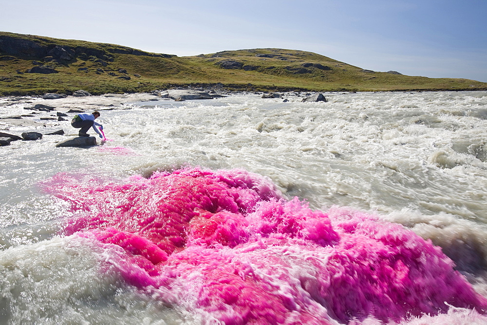 PHD scientist Ian Bartholomew using dye tracing techniques as part of a study to measure the speed of the Russell Glacier near Kangerlussuaq, Greenland, Polar Regions