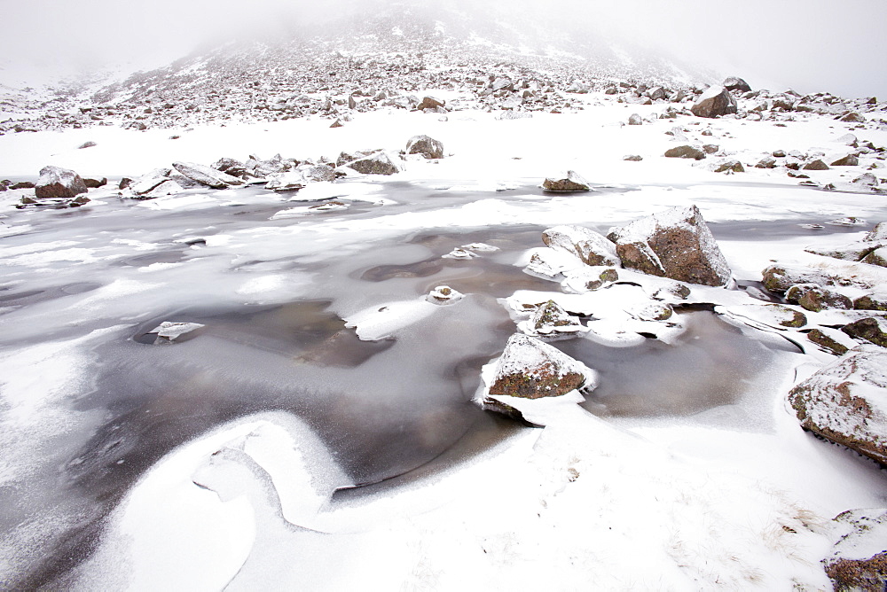 A frozen lochan in Coire an Sneachda in the Cairngorm Mountains, Scotland, United Kingdom, Europe