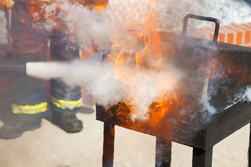 A C02 fire extinguisher being used to put out a blaze in a.fire fighting exercise as part of a BOSIET course for offshore workers, Billingham, Teesside, England, United Kingdom, Europe