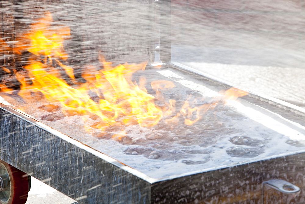 A foam extinguisher being used to put out a blaze in a.fire fighting exercise as part of a BOSIET course for offshore workers, Billingham, Teesside, England, United Kingdom, Europe