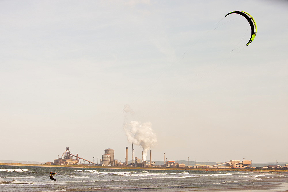 A Kite surfer in Teesmouth estuary, with the Redcar steel works behind, Teesside, England, United Kingdom, Europe