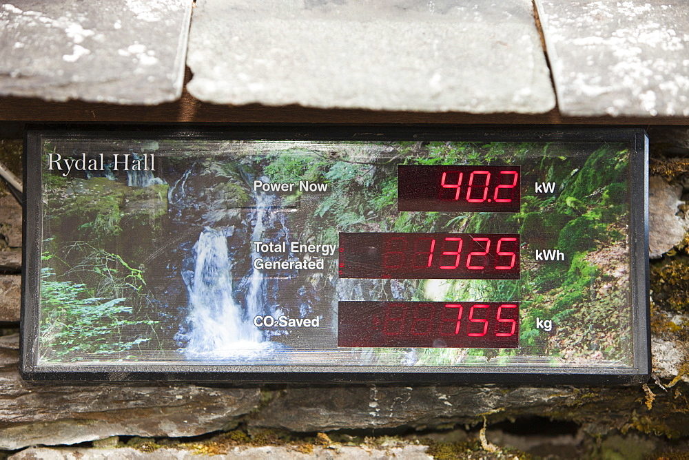 A display board showing the amount of renewable energy being generated by the micro hydro turbine in the grounds of Rydal Hall, Lake District Cumbria, England, United Kingdom, Europe