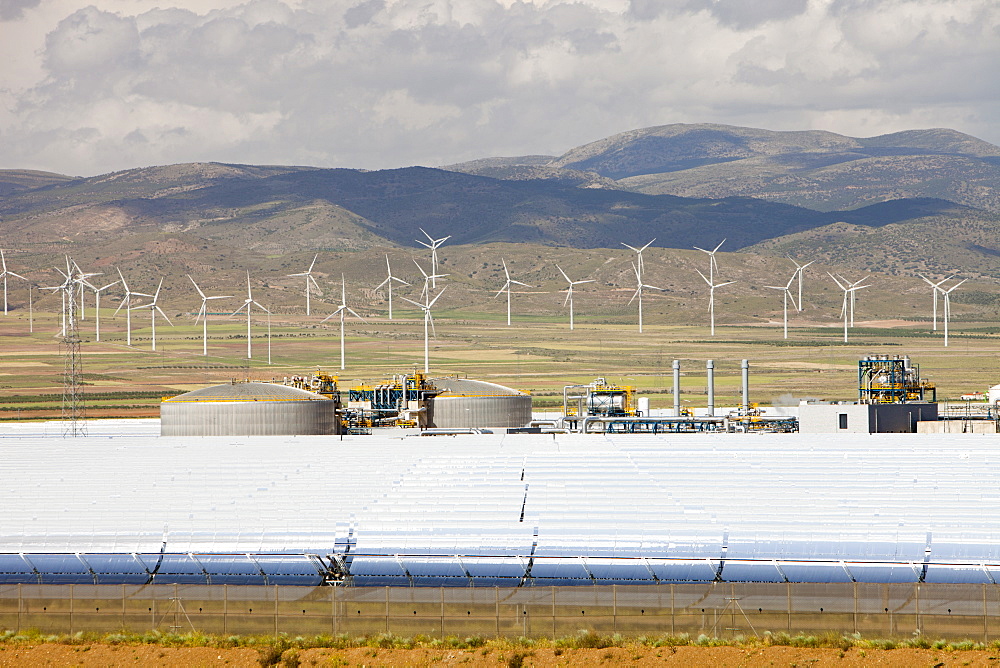 The Andasol solar power station near Guadix with a wind farm in the background, Andalucia, Spain, Europe