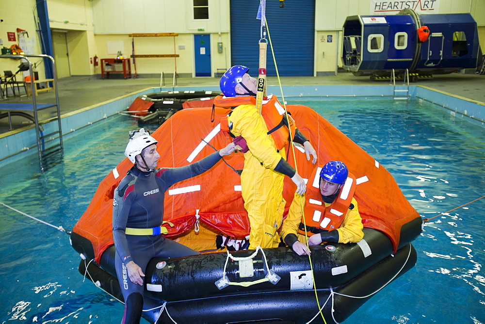 Workers in the offshore industry practise helicopter ditching evacuation as part of an industry training course, Billingham, Teesside, England, United Kingdom, Europe