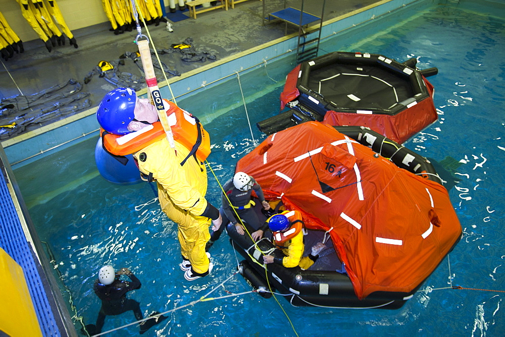 Workers in the offshore industry practise helicopter ditching evacuation as part of an industry training course, Billingham, Teesside, England, United Kingdom, Europe