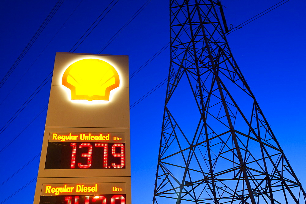 A petrol station and electricity pylon at dusk in Billingham on Teesside, England, United Kingdom, Europe