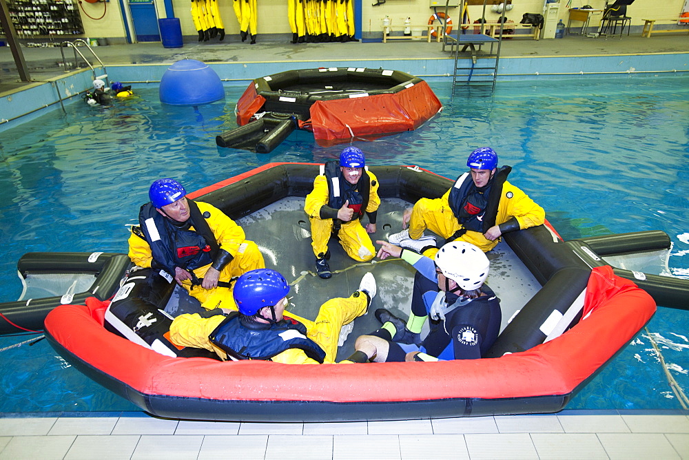 Workers in the offshore industry practise helicopter ditching evacuation as part of an industry training course, Billingham, Teesside, England, United Kingdom, Europe