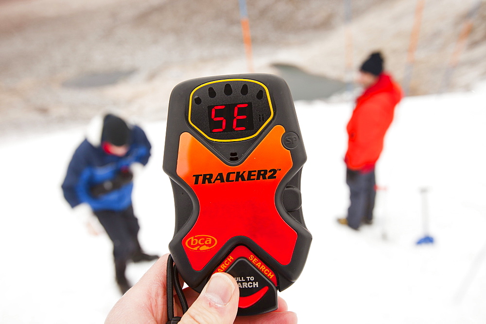 Mountaineers practise using avalanche transceivers in Coire an Lochain in the Cairngorms, Scotland, United Kingdom, Europe