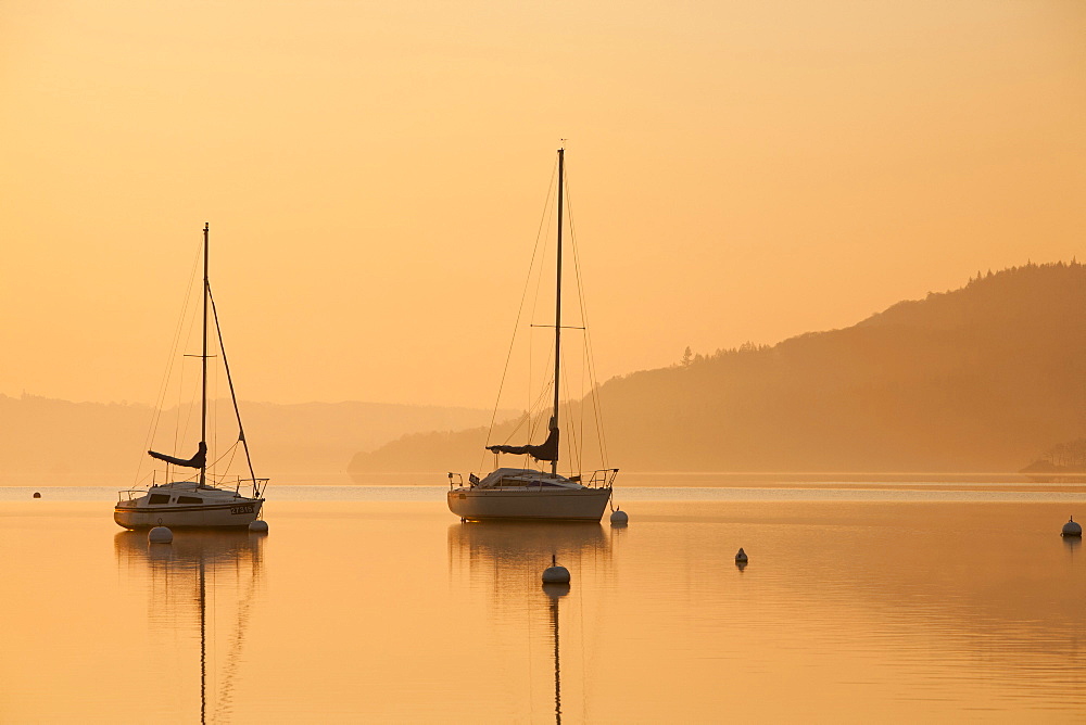 Sailing boats at dawn on Lake Windermere at Waterhead, Ambleside in the Lake District National Park, Cumbria, England, United Kingdom, Europe