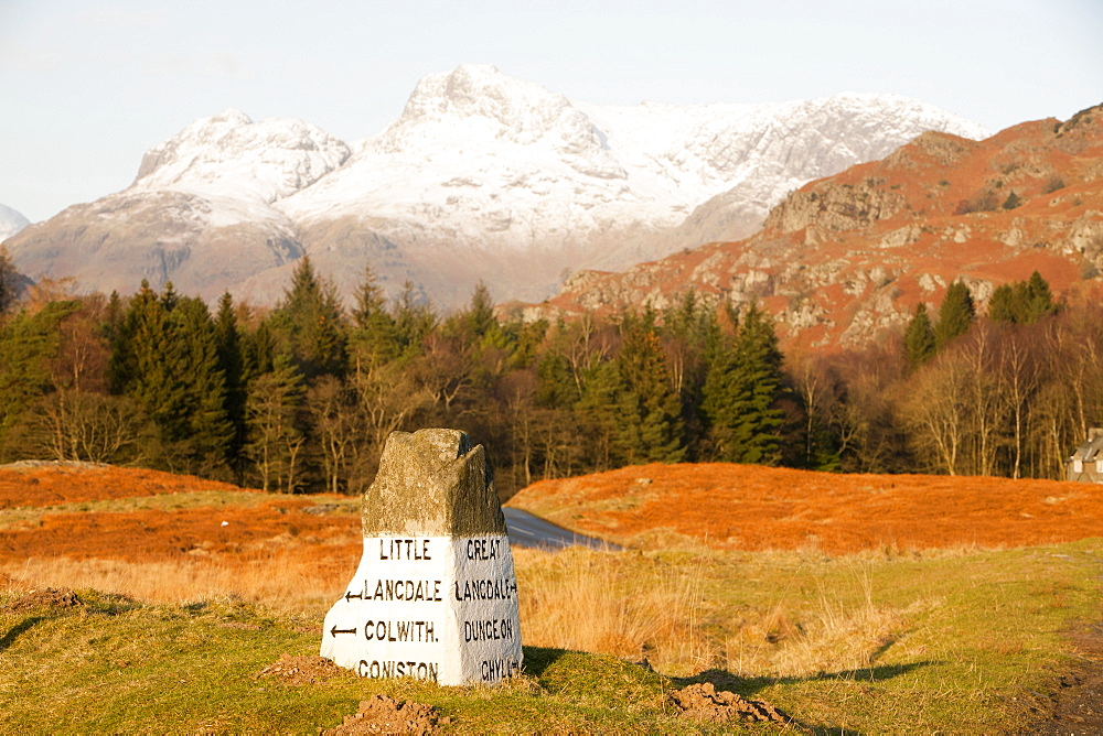 An old stone road sign in the Langdale valley at Elterwater looking towards the Langdale Pikes, Lake District National Park, Cumbria, England, United Kingdom, Europe