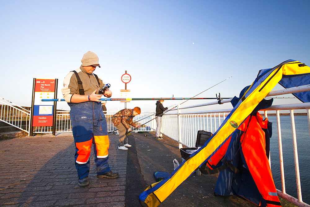 Fisherman sea fishing at Wearmouth in Sunderland, Tyne and Wear, England, United Kingdom, Europe