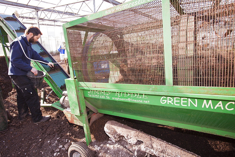 Riddling organic compost at Growing with Grace, an organic fruit and vegetable growing co-operative based in Clapham in the Yorkshire Dales, Yorkshire, England, United Kingdom, Europe