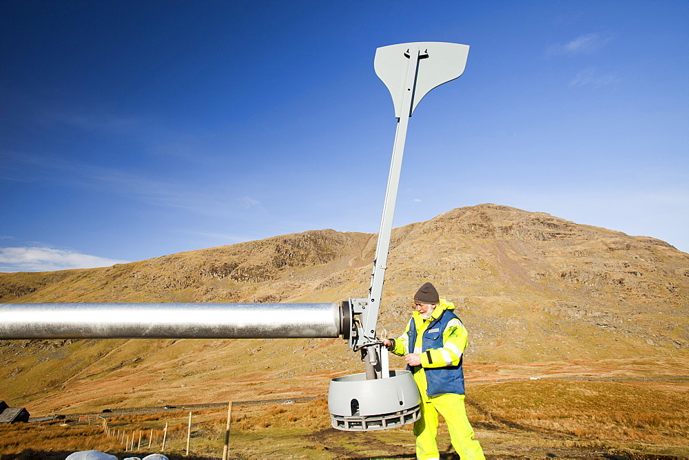 Three wind turbines being constructed behind the Kirkstone Pass Inn on Kirkstone Pass in the Lake District, Cumbria, England, United Kingdom, Europe