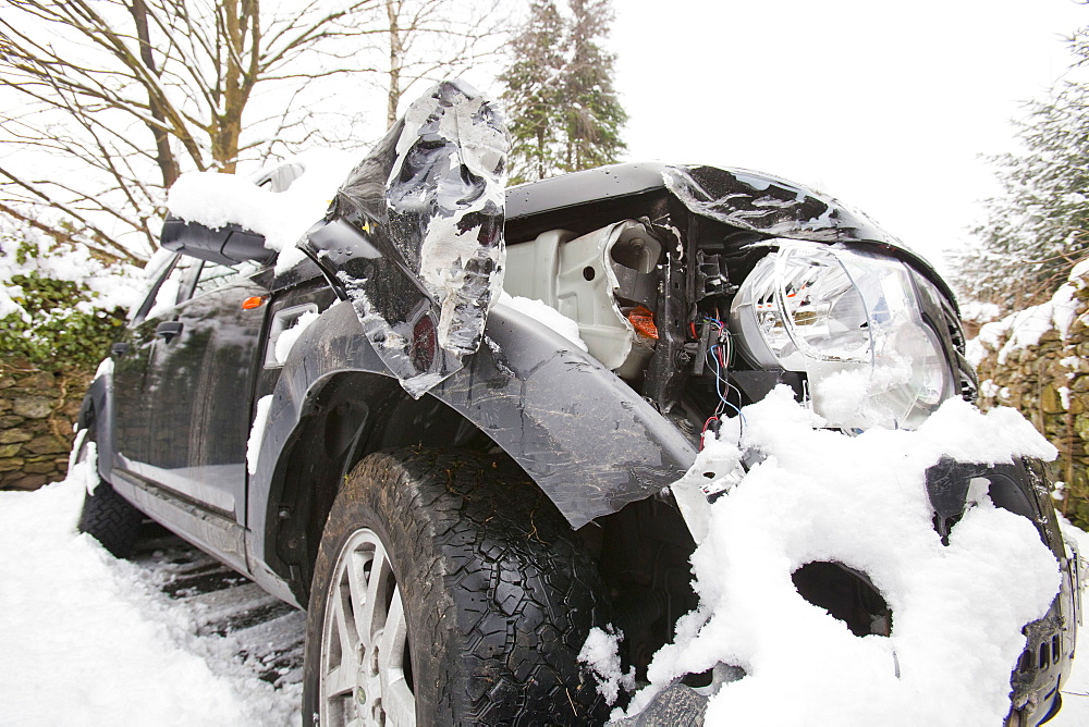 A Land Rover Discovery that slid into a wall in the snow on Kirkstone Pass above Ambleside in the Lake District, Cumbria, England, United Kingdom, Europe