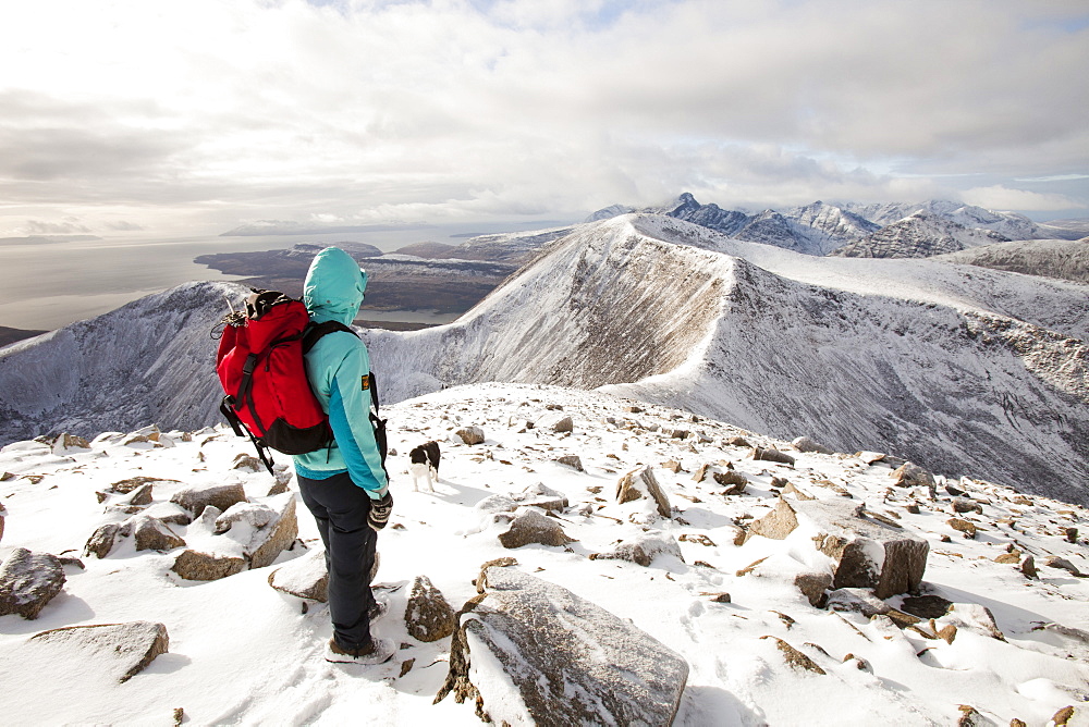 A female hill walker on the hills behind Broadford looking towards the Cuillin ridge on the Isle of skye, Scotland, United Kingdom, Europe