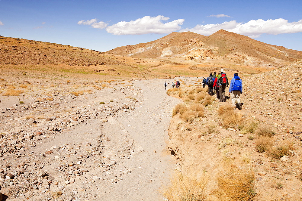 Trekkers cross a dried up river bed in the Anti Atlas mountains of Morocco, North Africa, Africa