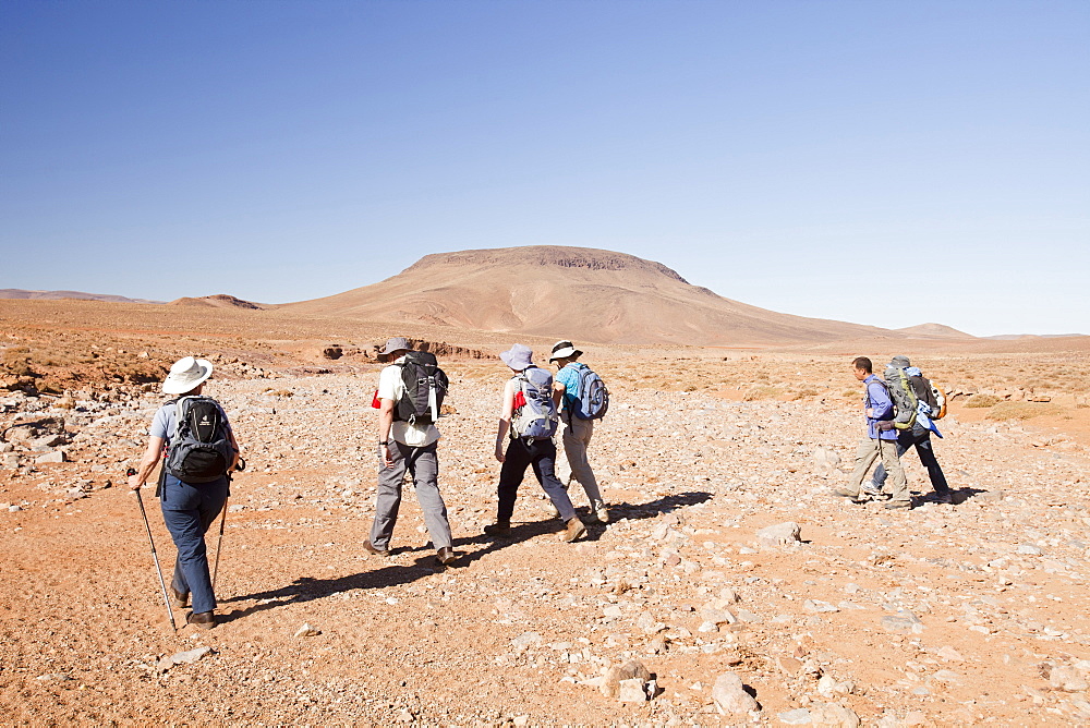 Trekkers cross a dried up river bed in the Anti Atlas mountains of Morocco, North Africa, Africa