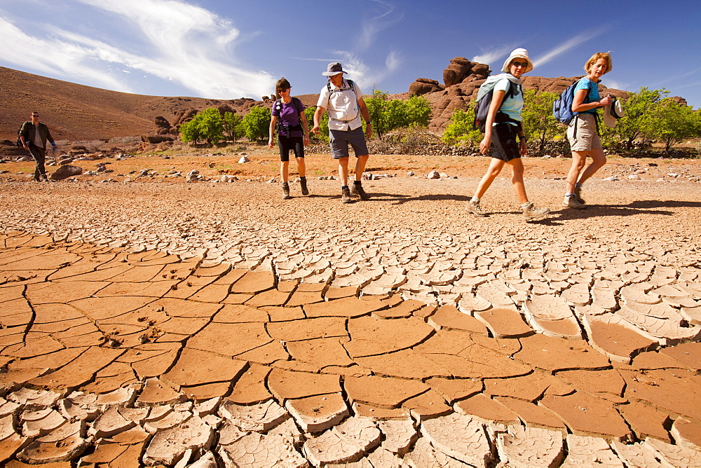 Trekkers pass a dried up river bed in the Anti Atlas mountains of Morocco, North Africa, Africa