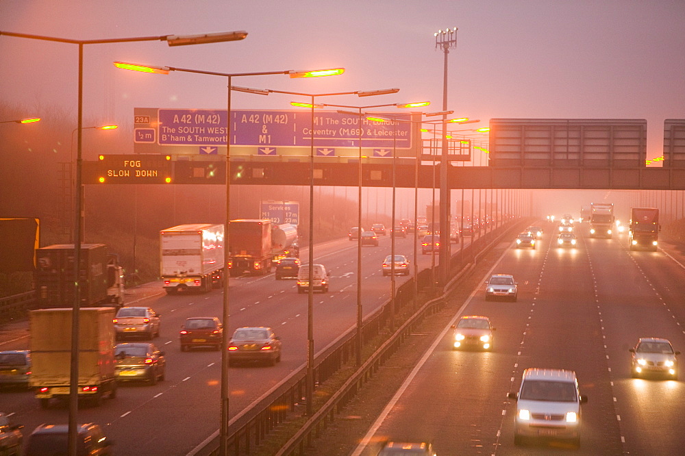 Cars driving in evening fog on the M1 motorway near Loughborough, Leicestershire, England, United Kingdom, Europe