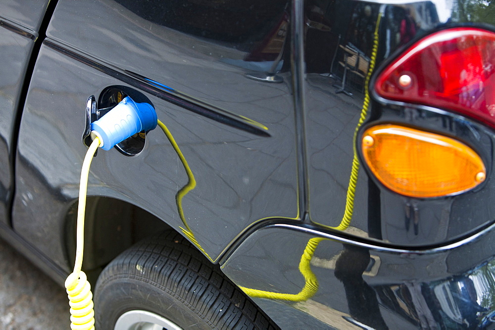 An electric vehicle at a recharging station on the street in Berkeley Square, London, England, United Kingdom, Europe