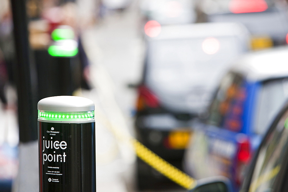 A row of electric vehicles at recharging stations on the street in Berkeley Square, London, England, United Kingdom, Europe