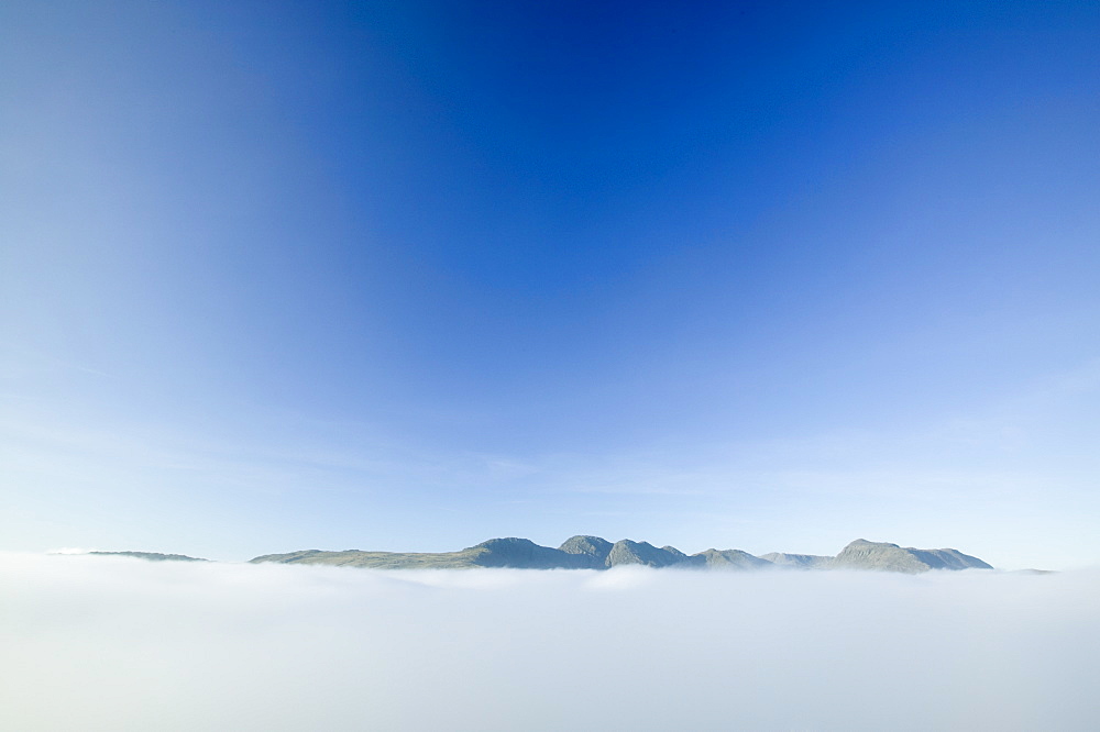 Above the clouds on Pike O Blisco looking towards Crinkle Crags and Bow Fell in the Lake District National Park, Cumbria, England, United Kingdom, Europe