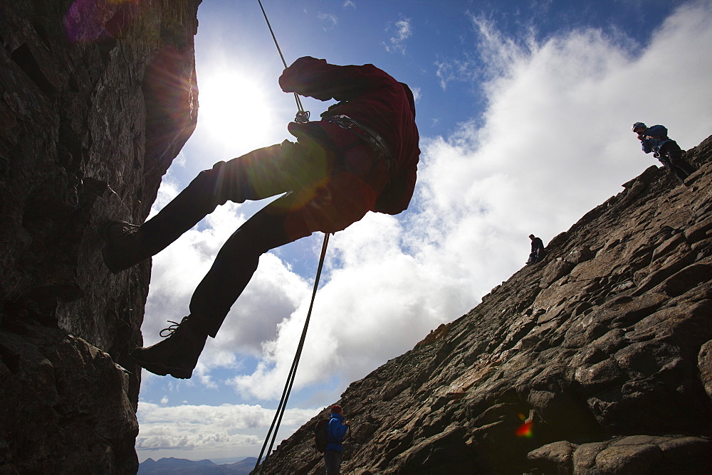 Climbers abseiling from the summit of the Inaccessible Pinnacle onto Sgurr Dearg in the Cuillin mountains, Isle of Skye, Scotland, United Kingdom, Europe