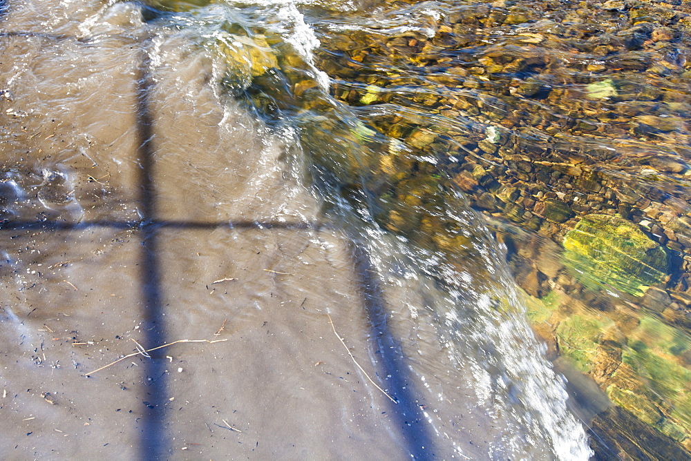 Raw sewage mixing with clean clear water in the River Kent in Kendal, Cumbria, England, United Kingdom, Europe