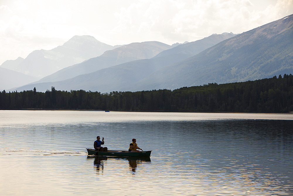 A couple in a Canadian canoe on Pyramid Lake near Jasper, Jasper National Park, UNESCO World Heritage Site, Alberta, Canadian Rockies, Canada, North America