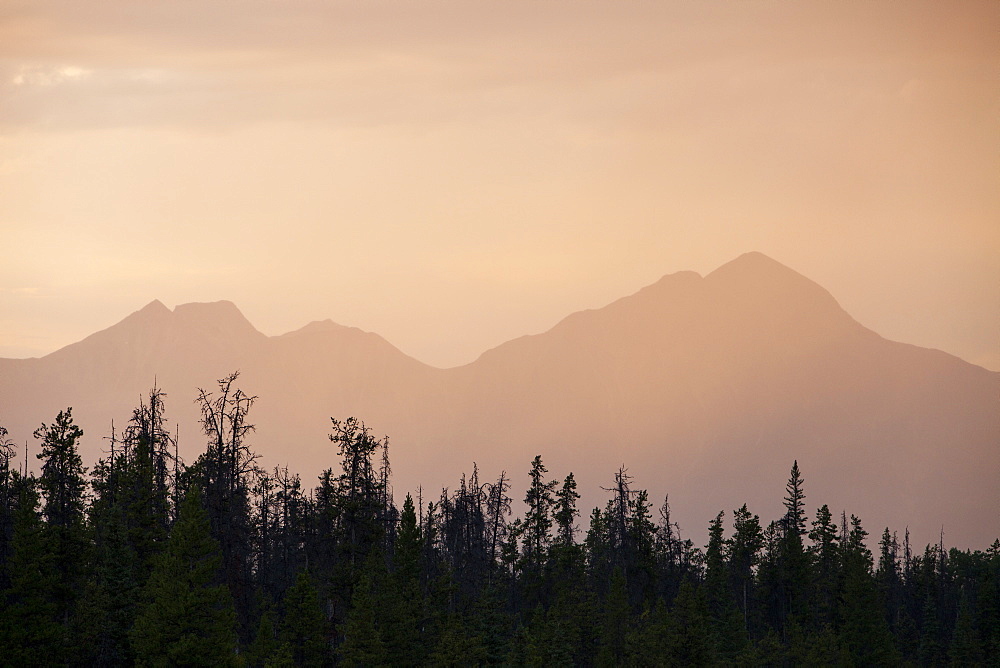 A rain shower at sunset over peaks near Jasper in the Rocky Mountains, Canada, North America