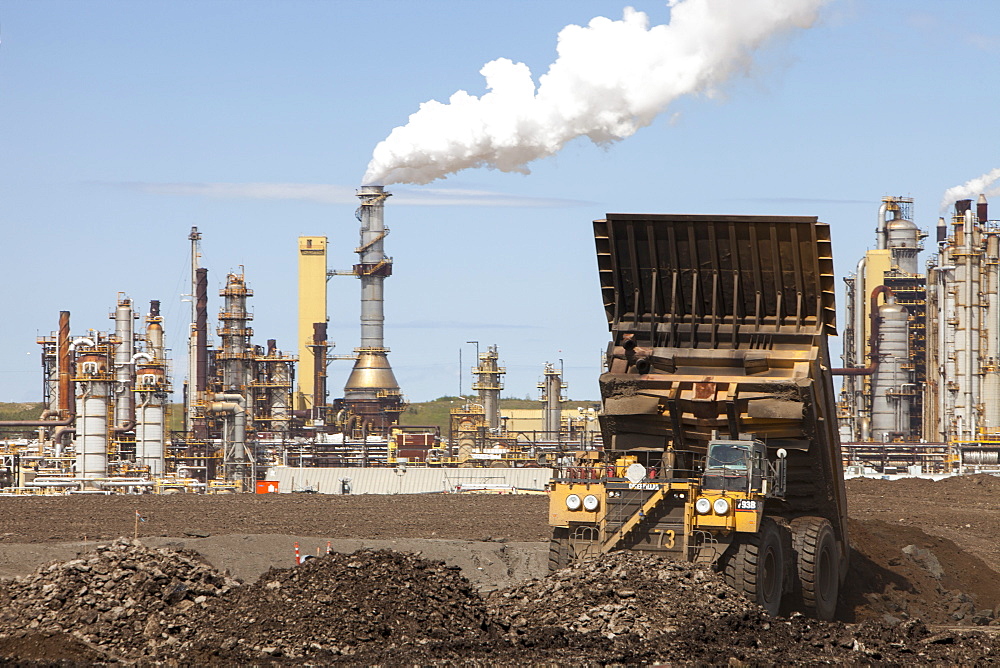 Massive dump trucks by the Syncrude upgrader plant, Alberta, Canada, North America