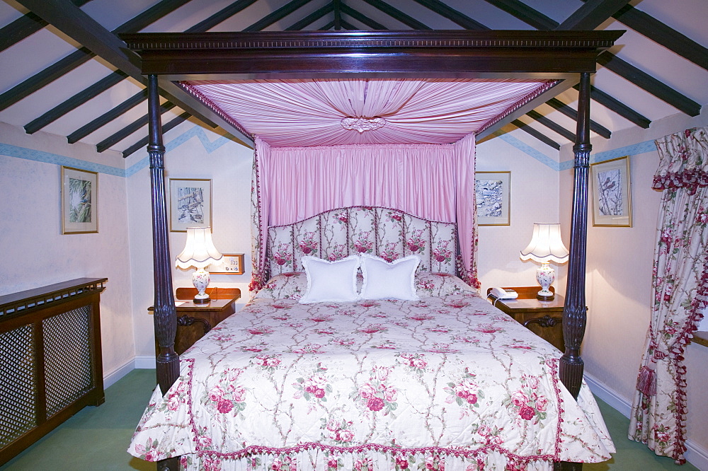 A four poster bed in a hotel bedroom, Lake District, Cumbria, England, United Kingdom, Europe