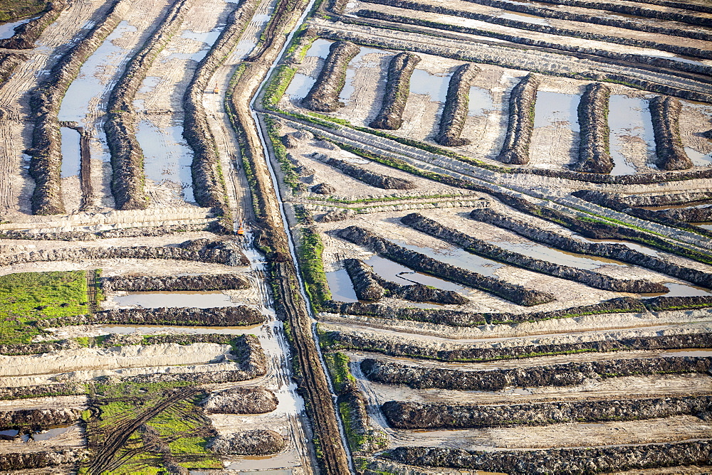 Soil overburden being removed to reach the tar sands beds in an open pit tar sands mine north of Fort McMurray, Alberta, Canada, North America